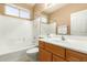 Bright bathroom with combined shower and tub, single sink vanity with wood cabinets at 3239 S Tatum Ln, Gilbert, AZ 85297