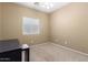 Simple bedroom featuring carpeted floors, a window, and a desk at 3239 S Tatum Ln, Gilbert, AZ 85297