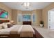 Comfortable bedroom features a wooden bed frame, carpet, and views to the backyard at 3239 S Tatum Ln, Gilbert, AZ 85297