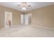 Large bedroom with neutral walls and carpet, showcasing ample space and closet access at 3239 S Tatum Ln, Gilbert, AZ 85297