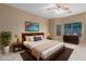 Comfortable bedroom features a wooden bed frame, carpet, and ensuite bathroom at 3239 S Tatum Ln, Gilbert, AZ 85297
