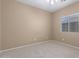 Neutral bedroom featuring carpeted floors and a large window offering natural light at 3239 S Tatum Ln, Gilbert, AZ 85297