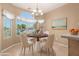 Bright dining area features a round table, four chairs, and large windows with neighborhood views at 3239 S Tatum Ln, Gilbert, AZ 85297