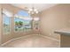 Bright dining area featuring tile floors, a modern chandelier, and large window at 3239 S Tatum Ln, Gilbert, AZ 85297