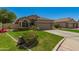 Single-story house with well-maintained lawn, mature landscaping, and two-car garage at 3239 S Tatum Ln, Gilbert, AZ 85297