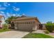 Single-story house featuring a well-kept lawn, tile roof, and a two-car garage at 3239 S Tatum Ln, Gilbert, AZ 85297