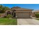Charming single-story home featuring a well-maintained lawn and a two-car garage at 3239 S Tatum Ln, Gilbert, AZ 85297