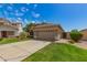 Single-story house featuring a well-kept lawn, tile roof, and a two-car garage at 3239 S Tatum Ln, Gilbert, AZ 85297