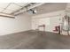 Spacious two car garage featuring a work bench and water heater at 3239 S Tatum Ln, Gilbert, AZ 85297