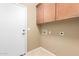 Functional laundry room featuring overhead cabinets and washer and dryer hookups at 3239 S Tatum Ln, Gilbert, AZ 85297