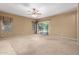 Open living area with carpet flooring, a ceiling fan, and sliding glass door at 3239 S Tatum Ln, Gilbert, AZ 85297