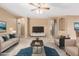 Spacious living room with neutral tones, comfortable seating, modern TV console, and stylish decor at 3239 S Tatum Ln, Gilbert, AZ 85297