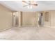 A spacious living room featuring neutral tones, carpeted floors, and archways that add architectural detail at 3239 S Tatum Ln, Gilbert, AZ 85297