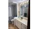 Well-lit bathroom with vanity, toilet, and shower featuring a shower curtain and grab bar at 3330 E Main St # 256, Mesa, AZ 85213