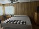 Cozy bedroom features wood paneling, a ceiling fan, and a window at 3330 E Main St # 256, Mesa, AZ 85213