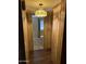 Hallway features wood paneling and flooring leading to other rooms at 3330 E Main St # 256, Mesa, AZ 85213