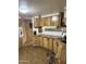 A functional kitchen featuring wood cabinetry, laminate countertops, and essential appliances for meal preparation at 3330 E Main St # 256, Mesa, AZ 85213