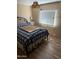 Inviting bedroom with a metal-frame bed, patterned bedding, and natural light from the window at 3330 E Main St # 256, Mesa, AZ 85213