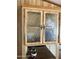 Close-up view of wood cabinets with decorative glass door fronts and classic hardware at 3330 E Main St # 256, Mesa, AZ 85213