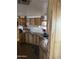 Well-lit kitchen featuring wood cabinets, a stainless steel sink, and countertop space at 3330 E Main St # 256, Mesa, AZ 85213