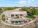 Stunning aerial view of a home with a pool, spa, covered patio, and mature landscaping at 34096 N 87Th Way, Scottsdale, AZ 85266