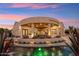 Stunning backyard pool with unique lighting and covered patio, perfect for evening relaxation at 34096 N 87Th Way, Scottsdale, AZ 85266