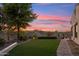 Beautiful backyard with lush lawn, landscaping, and desert views beyond the property at 34096 N 87Th Way, Scottsdale, AZ 85266