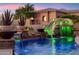 Spectacular backyard with a rock waterfall feature flowing into the pool at 34096 N 87Th Way, Scottsdale, AZ 85266