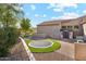 Well-manicured backyard with green grass, a sunken trampoline, and a bonus storage shed at 34096 N 87Th Way, Scottsdale, AZ 85266