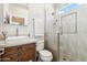 Bathroom featuring a glass-enclosed shower, modern sink, and a large framed mirror at 34096 N 87Th Way, Scottsdale, AZ 85266