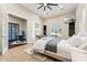 Bright bedroom with white trim, ceiling fan, attached study, a view of outside with a cactus and neutral walls at 34096 N 87Th Way, Scottsdale, AZ 85266