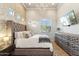 Bedroom featuring a king bed with a tufted headboard, designer wallpaper, chandelier, and a wall-mounted TV at 34096 N 87Th Way, Scottsdale, AZ 85266
