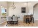 Dining area featuring a modern light fixture, bar area with stone accents and wine storage at 34096 N 87Th Way, Scottsdale, AZ 85266