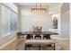 Bright dining room with tile floors, a modern light fixture, and built-in niche display at 34096 N 87Th Way, Scottsdale, AZ 85266