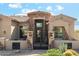 Inviting front exterior with stone accents, iron gate, and well-maintained landscaping at 34096 N 87Th Way, Scottsdale, AZ 85266