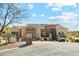 Attractive home exterior featuring desert landscaping, stonework, and a circular driveway at 34096 N 87Th Way, Scottsdale, AZ 85266
