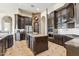 Expansive kitchen features dark wood cabinets, an island with granite countertops, and stainless steel appliances at 34096 N 87Th Way, Scottsdale, AZ 85266