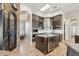 Gourmet kitchen with a large center island, wine storage, stainless steel appliances, and custom cabinetry at 34096 N 87Th Way, Scottsdale, AZ 85266