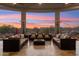 Inviting covered patio featuring comfortable seating, heaters and scenic sunset views at 34096 N 87Th Way, Scottsdale, AZ 85266
