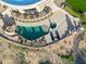 Aerial view of a beautiful pool and spa area with a rock slide, tanning deck, and desert landscaping at 34096 N 87Th Way, Scottsdale, AZ 85266