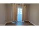 Bedroom featuring wood floors, window and patio door with white curtains and trim at 3434 E Baseline Rd # 168, Phoenix, AZ 85042