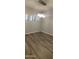 Bedroom features modern chandelier and wood-look flooring with three large windows at 3434 E Baseline Rd # 168, Phoenix, AZ 85042