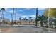 Entrance to the Raven Condominiums with palm trees and views of surrounding mountains at 3434 E Baseline Rd # 168, Phoenix, AZ 85042
