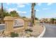 Inviting sign at The Raven Condominiums entrance with desert landscaping and visible building features at 3434 E Baseline Rd # 168, Phoenix, AZ 85042