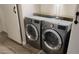 The laundry room features a side-by-side washer and dryer set with overhead shelving at 3434 E Baseline Rd # 168, Phoenix, AZ 85042