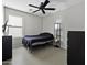 Simple bedroom with black ceiling fan and a streamlined design for restful nights at 40749 W Thornberry Ln, Maricopa, AZ 85138
