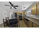 This kitchen features stainless steel appliances, granite countertops, and a cozy dining area at 40749 W Thornberry Ln, Maricopa, AZ 85138