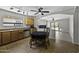 Eat-in kitchen boasts stainless steel appliances, ceiling fan, and easy access to backyard at 40749 W Thornberry Ln, Maricopa, AZ 85138