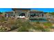 Wide shot of home's backyard with desert landscaping, inground pool and seating area at 41639 N 113Th Pl, Scottsdale, AZ 85262