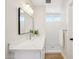 Bathroom featuring a white vanity with marble countertop, contemporary mirror and step-in shower at 4521 W Buffalo St, Chandler, AZ 85226
